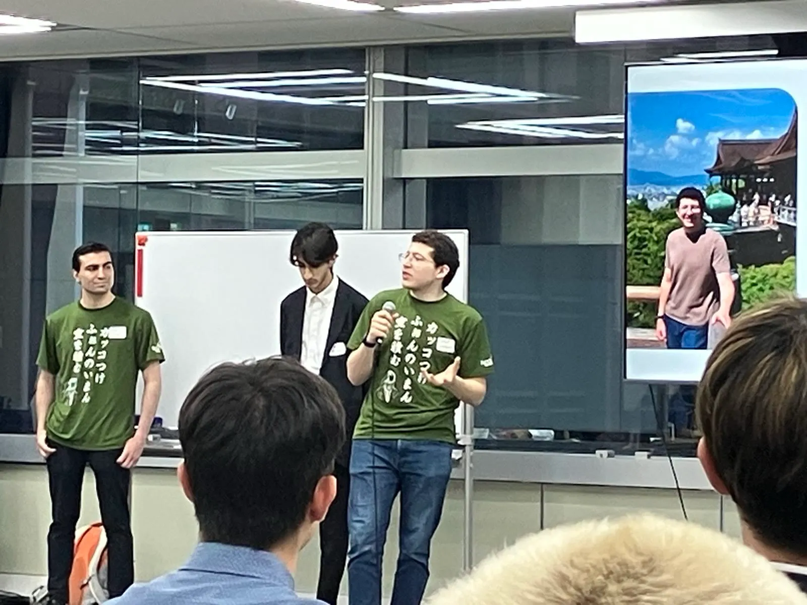 The three of us on stage in our matching company T-shirts, with me talking